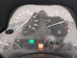 a close up of a car dashboard with a speedometer and gauges