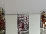 three glass vases sitting on a table with different designs on them