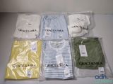 a lot of clothes that are sitting on a table