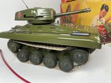 a toy tank sitting on a table next to a box