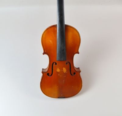 un gros plan d'un violon posé sur une surface blanche