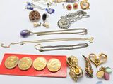 a lot of jewelry that is laying out on the table