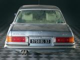 a silver car that is parked on a checkered floor