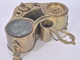 an old brass plate with a teapot on top of it