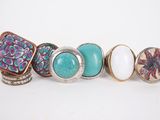 a group of five rings with different designs on them