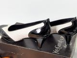 pair of black and white shoes sitting on top of a box