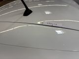 a close up of a white car with a sticker on it