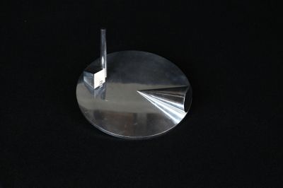 a close up of a metal object on a black surface