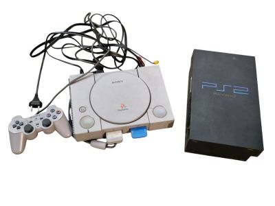 a video game console and a game controller next to a box