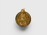 a gold coin with an image of a man on a horse