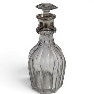 an image of a clear glass bottle with a silver lid