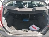 the back of a car with the trunk open and a bottle of water in the trunk