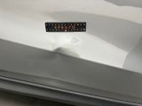 the rear end of a silver car with a sticker on it ' s bumper