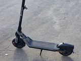 a scooter that is sitting in the parking lot