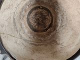 an overhead view of a pot on a table with screws and wrenches