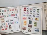 two open books with stamps on them sitting on a table