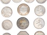 a close up of a bunch of coins on a white surface