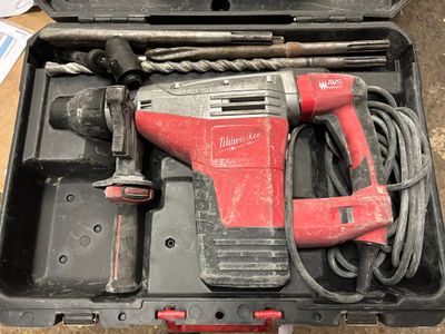 une perceuse à fil rouge dans une mallette avec d'autres outils