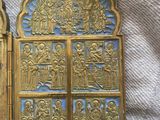 pair of gold and blue metal religious doors on a white cloth