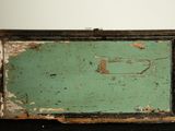 an old wooden box with peeling paint on it