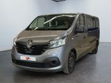 the silver van is parked in a large room with a ceiling fan