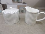 pair of creamer and sugar shaker in white and grey striped pattern