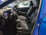 the interior of a blue car with black leather seats and a steering wheel