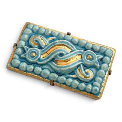 a picture of a blue and gold broochle on a white background
