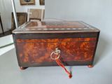 a small wooden box with a handle on it