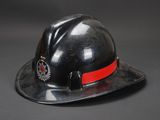 fireman ' s hard hat with a red band around the brim