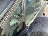 a broken window of a car with a bullet on it