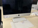 a desk with a computer monitor and keyboard on it