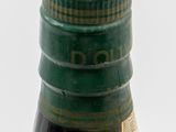 a bottle of black liquid sitting on a white surface