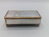 a silver and gold box with a bird on it