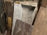 several pieces of wood are stacked up in a pile in the corner of a room