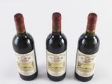 three bottles of wine sitting on top of a white surface