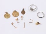 several rings and earrings are arranged on a white surface