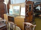 several chairs and a table in a room with a mirror on top of it