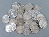 a pile of silver coins sitting on a table
