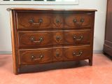 a wooden dresser with many drawers in a room