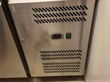 a stainless steel oven in a kitchen with tile flooring