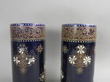 pair of blue and gold vases on a white background