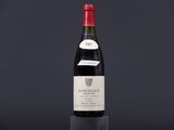 a bottle of wine sitting on top of a black table