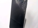 a broken cell phone sitting on top of a stand