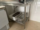 a microwave sitting on top of a stainless steel table