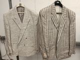 two jackets hanging on a clothes rack in a room