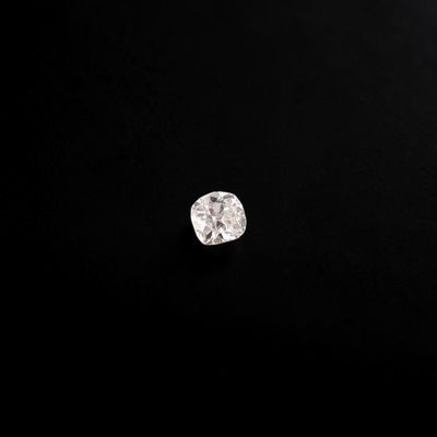 a close up of a diamond on a black surface