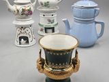 five different teapots and a tea pot on a table