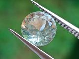 un gros plan d'un diamant tenu par une pince