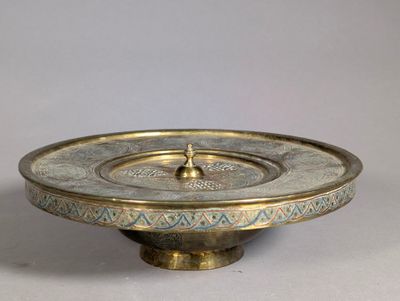 an image of a brass plate with a decorative design on it
